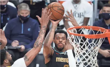  ?? JOE RONDONE/THE COMMERCIAL APPEAL ?? Memphis Grizzlies forward Xavier Tillman shoots the ball over Los Angeles Lakers center Anthony Davis during their game at the Fedexforum on Tuesday Jan. 5, 2021.