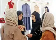  ?? ?? Visitors, including fashion and clothing designers, visit the annual exhibition on fashion and clothes designed by young Iranian designers.