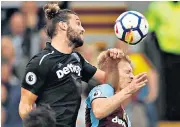  ??  ?? Red mist: West Ham’s Andy Carroll lunges into Ben Mee of Burnley to earn a second booking and a red card that proved the turning point of the match