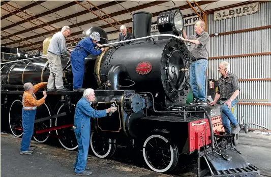  ?? JOHN BISSET/ STUFF ?? Preparing AB699 for the Pleasant Point Railway Museum’s, 50th anniversar­y, 1970 – 2020 special steaming day, tomorrow are, from left, Barry Cain, Les Coombes, Neville Walker, Mike Shears (top rear) Alf Dowall, Bryan Blanchard, and Stewart Frew.