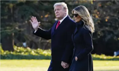  ?? Photograph: Evan Vucci/AP ?? Donald and Melania Trump walk to board Marine One on the South Lawn of the White House on Wednesday to travel to Florida for the festive break.