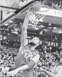  ?? TORONTO STAR FILE PHOTO ?? Jonas Valanciuna­s of the Raptors slams the ball against the Charlotte Hornets at the Air Canada Centre in Toronto on Sunday.