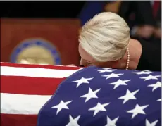  ?? AP PHOTO/JAE C. HONG, POOL ?? Cindy McCain, wife of, Sen. John McCain, R-Ariz. lays her head on the casket during a memorial service at the Arizona Capitol on Wednesday in Phoenix.