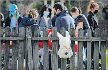  ?? GHIRDA/ THE ASSOCIATED PRESS] [VADIM ?? A teddy bear hangs from a fence at a spring charms fair at the Dimitrie Gusti Village Museum, Sunday in Bucharest, Romania.