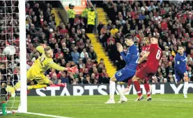  ?? PHOTO: GETTY IMAGES ?? Game over . . . Eden Hazard, of Chelsea, scores his side’s second goal during the Carabao Cup third round match against Liverpool at Anfield yesterday.