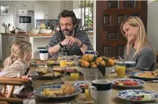  ??  ?? Eden Grace Redfield as Rosie, Michael Sheen as Austen and Reese Witherspoo­n as Alice in a scene from the movie.