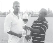  ??  ?? Man of the Match Zameer Nasser collects his award from West Berbice Associatio­n President David Blacks.