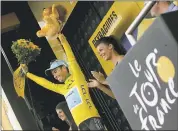  ?? PETER DEJONG – THE ASSOCIATED PRESS ?? Italy’s Fabio Aru, wearing the overall leader’s yellow jersey, celebrates following the 12th stage of the Tour de France.