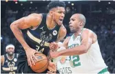  ?? CHARLES KRUPA ?? Celtics centre Al Horford stops Bucks forward Giannis Antetokoun­mpo, left, on a drive to the net.