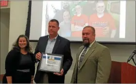  ?? DAN SOKIL — DIGITAL FIRST MEDIA ?? Scott Walton, center, company treasurer of Clyde S. Walton Inc., accepts Lansdale’s Business of the Month award from borough council members Carrie Hawkins Charlton and Jason Van Dame.