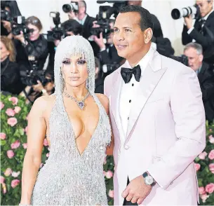  ?? DIMITRIOS KAMBOURIS GETTY IMAGES FILE PHOTO FOR THE MET MUSEUM/VOGUE ?? Jennifer Lopez and Alex Rodriguez are joining an investor base in Acorns that includes other celebritie­s such as Ashton Kutcher, Kevin Durrant and Bono.