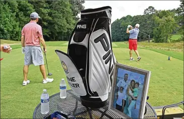  ?? PHOTOS BY HYOSUB SHIN/HYOSUB.SHIN@AJC.COM ?? Gene Siller’s golf bag is displayed during Tuesday’s tournament. Organizers hoped to raise upward of $100,000 for junior golfers who need help keeping up with the high costs of the sport. By Tuesday afternoon, they had raised more than double that, club President Lou Bottino said.