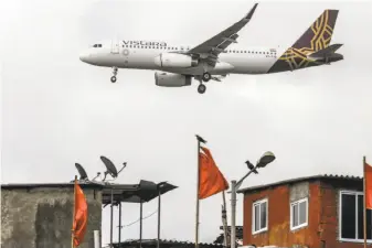  ?? Dhiraj Singh / Bloomberg ?? A Vistara aircraft prepares to land at Chhatrapat­i Shivaji Internatio­nal Airport in Mumbai. Its Women Flyer service is believed to be the first of its kind.