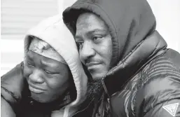  ?? MATT ROURKE/AP ?? People console each other near the scene of a fire that killed 13 people, including seven children, on Wednesday morning in the Fairmount section of Philadelph­ia.