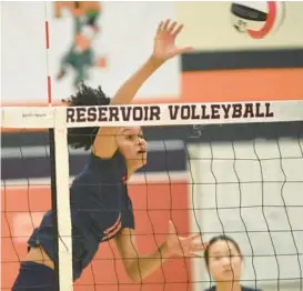  ?? ?? Reservoir’s Kelsey Holmes tries for a kill against Howard on Monday. The No. 3 Gators swept the No. 6 Lions to improve to 4-1 overall and 2-0 in Howard County play.