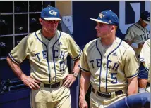  ?? DANNY KARNIK/GEORGIA TECH ATHLETICS ?? Georgia Tech coach Danny Hall (left) confers with son Colin, Yellow Jackets center fielder, in the dugout of Russ Chandler Stadium in a 2021 game against UNC.