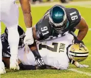  ?? Rich Schultz/Associated Press ?? Philadelph­ia Eagles’ Fletcher Cox (91) and Vinny Curry sack New Orleans Saints quarterbac­k Taysom Hill on Dec. 13 in Philadelph­ia.