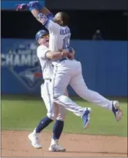  ?? FRED THORNHILL — THE CANADIAN PRESS VIA AP ?? Toronto Blue Jays Edwin Encarnacio­n jumps into the arms of teammate Josh Donaldson after he drove in the winning run in the ninth inning of their baseball game in Toronto, Sunday.