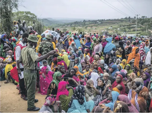  ?? AFP ?? Ethiopian refugee women wait to receive items distribute­d by the Kenyan Red Cross at the Somare refugee camp in Moyale, a Kenyan border town