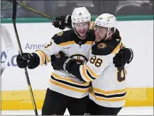  ?? TONY GUTIERREZ — THE ASSOCIATED PRESS ?? Boston’s Pavel Zacha, left, and David Pastrnak celebrate after Zacha scored the tying goal in the third period against the Stars at Dallas.