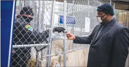  ?? Tribune News Service/minneapoli­s Star-tribune ?? Rodney Floyd, brother of George Floyd, handed his identifica­tion to security to enter the perimeter of the Hennepin County Government Center at the start of the trial day.