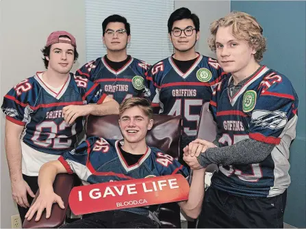  ?? JESSICA NYZNIK EXAMINER ?? Some members of the Thomas A. Stewart Griffins senior boys football team give blood Tuesday afternoon at the In Honour of Braidyn Blood Drive at the Canadian Blood Services clinic on George Street in Peterborou­gh.