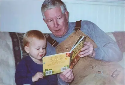  ?? Norman family via AP ?? This 2001 photo provided by the Norman family shows Dr. Richard Norman reading to his grandson Eric Walter in Annapolis, Md. At 84, the former athlete-turned-dentist and father of four had been struggling with Parkinson’s.The few choices Norman had...