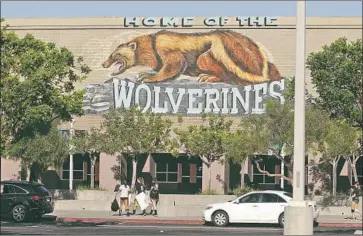  ?? Marc Martin Los Angeles Times ?? ALISO NIGUEL students at a football game displayed a sign that read “We like White,” which the school said was taken out of context — other signs said “We like Red” and “We like Blue,” all meant to celebrate the f lag.