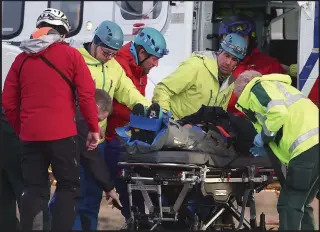  ??  ?? Rescue: An injured climber is taken from the Coastguard helicopter