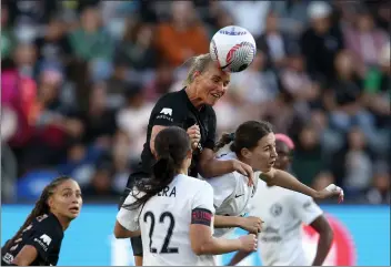  ?? PHOTO BY RAUL ROMERO JR. ?? Angel City FC's Amandine Henry, top, heads the ball against Bay FC in Sunday's NWSL season opener at BMO Stadium.