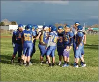  ??  ?? The Hamilton High football team huddles during practice Wednesday afternoon in Hamilton City.