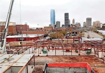  ?? [PHOTOS BY JIM BECKEL, THE OKLAHOMAN] ?? The downtown skyline is seen from atop the future AC Hotel being built in east Bricktown.