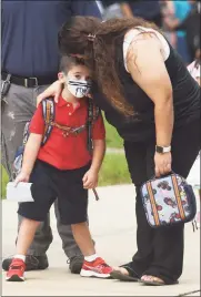  ?? Tyler Sizemore / Hearst Connecticu­t Media ?? Jenna Camillo drops off her son, Michael, on his first day of kindergart­en at Newfield Elementary School in Stamford on Monday. Stamford Public Schools students returned to class Monday to kick off in-person learning for the 2021-22 school year.