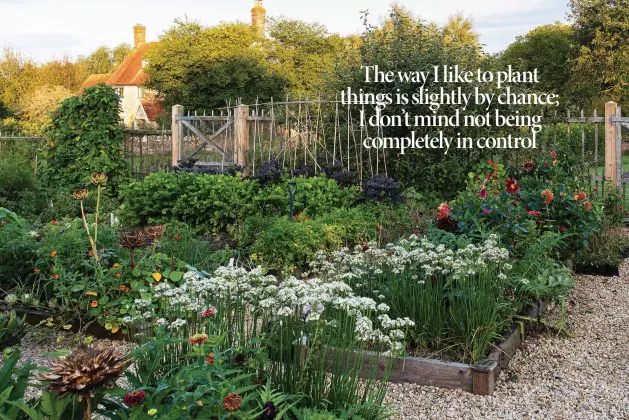  ??  ?? Above With its beds packed with cutting flowers, abundant fruit and vegetables, edgings of star-flowered garlic chives and tangles of nasturtium, Patricia’s enormous, productive garden is as beautiful as every other part of the garden. Here, safe from rabbits and deer, her gardener Selina grows hundreds of annuals each year to supplement the flower borders.