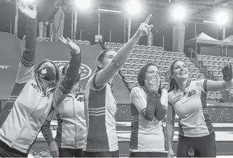  ?? ANDREW KLAVER, CURLING CANADA • SPECIAL TO POSTMEDIA NEWS ?? Masked-up coach Heather Nedohin, far left, celebrates with the Scotties Tournament of Hearts gold medal-winning Kerri Einarson rink in Calgary on Feb. 28.