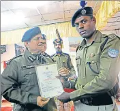  ??  ?? Constable Raghunath Ghait (left) being awarded by CRPF director general RR Bhatnagar in Srinagar on Thursday. WASEEM ANDRABI/HT