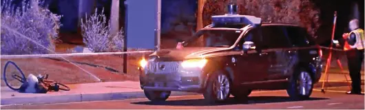  ??  ?? Fatal crash: The self-driving car and a bicycle – thought to be the victim’s – at the scene of the accident in Arizona yesterday
