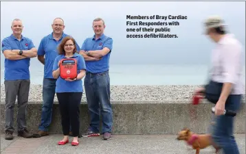  ??  ?? Members of Bray Cardiac First Responders with one of their public access defibrilla­tors.