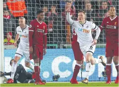  ?? AFP ?? Swansea City’s Alfie Mawson, No.6, celebrates his goal against Liverpool.