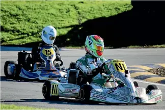  ?? PHOTO: FAST COMPANY/EMILEE JANE PHOTOGRAPH­Y ?? Jackson Rooney, right, here leading Kaleb Ngatoa during the New Zealand secondary schools karting championsh­ips at Blenheim. Rooney and the Palmerston North Boys’ High School team won the national title.
