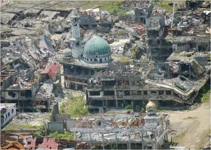  ??  ?? THIS March 28 photo shows an aerial shot of a destroyed mosque in Marawi City, in southern island of Mindanao, after five months of house-to-house fighting between troops and jihadists loyal to the Islamic State group that killed nearly 1,200.