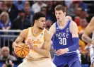  ?? Photograph: Matt Pendleton/USA Today Sports ?? Tennessee forward Olivier Nkamhoua, left, is defended by Duke center Kyle Filipowski during Saturday’s first half.