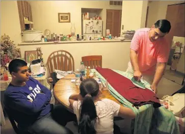  ?? Chris Sweda Chicago Tribune ?? JUAN SOTO, who graduated from a program to be a certified nursing assistant, hopes to further his studies to become a trauma nurse or a doctor to set an example for his two children, Nicholas, 13, left, and Jocelyn, 10.