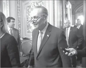  ?? AP Photo/J. Scott Applewhite ?? Party leader : Senate Minority Leader Chuck Schumer, D-N.Y., heads to the chamber with fellow Democrats for a procedural vote aimed at reopening the government, at the Capitol in Washington, Monday.