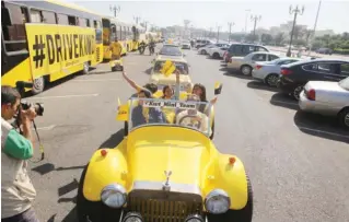  ??  ?? KUWAIT: Over 100 yellow cars, buses and motorbikes take to Gulf Road yesterday to promote compassion­ate driving, like following traffic rules, giving way to others and being considerat­e and cheerful on the road. The Yellow Parade, which coincides with...
