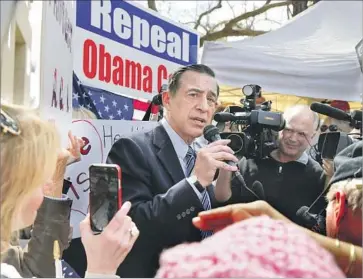  ?? Photograph­s by Howard Lipin San Diego Union-Tribune ?? DARRELL ISSA called the impromptu session a step “toward positive discourse that will allow us to really, really, get some solutions on immigratio­n, on healthcare, and about a Middle East that is blowing up.”