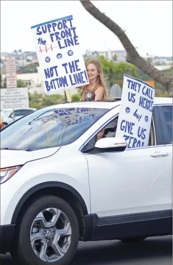  ??  ?? A vehicle shows support for health care workers as it winds past Maui Memorial.