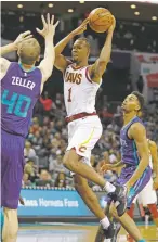  ?? BOB LEVERONE/ASSOCIATED PRESS ?? The Cavaliers’ Rodney Hood looks to shoot or pass around the Hornets’ Cody Zeller on Saturday in Charlotte, N.C. The Hornets won 126-94.