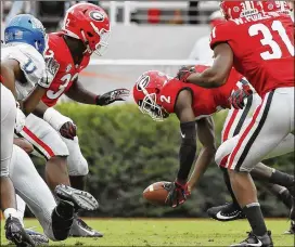  ?? BOB ANDRES /BANDRES@AJC.COM ?? Georgia defensive back Richard LeCounte scoops up a fumble in the first half of the Bulldogs’ 49-7 win over Middle Tennessee on Saturday.