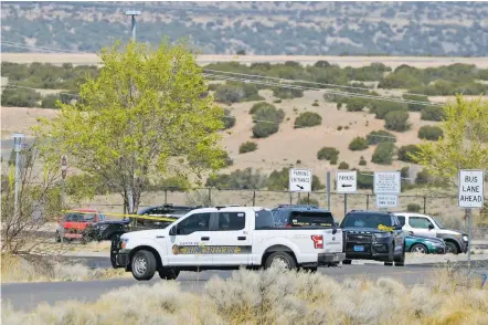  ?? MATT DAHLSEID/THE NEW MEXICAN ?? Santa Fe police vehicles gather at the scene of a reported carjacking Monday morning at the N.M. 599 Rail Runner Express station.